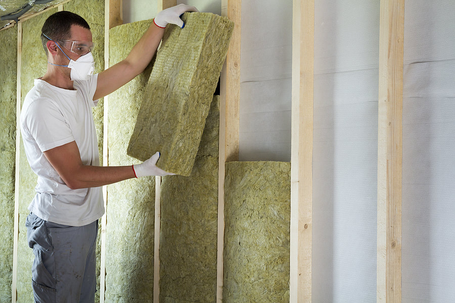 Person installing insulation in Wilton, CT.