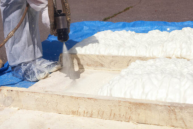 Technician spraying foam insulation in wilton 